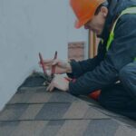 Man installing roof on home